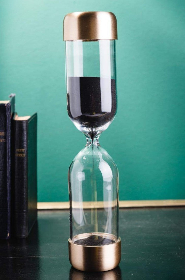 Sand Timer – Satin Brass and Black Sand on table with books