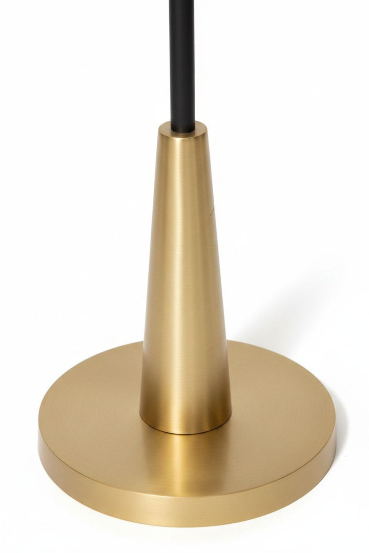 White Whisper floor lamp with a black stem and brushed gold circular base